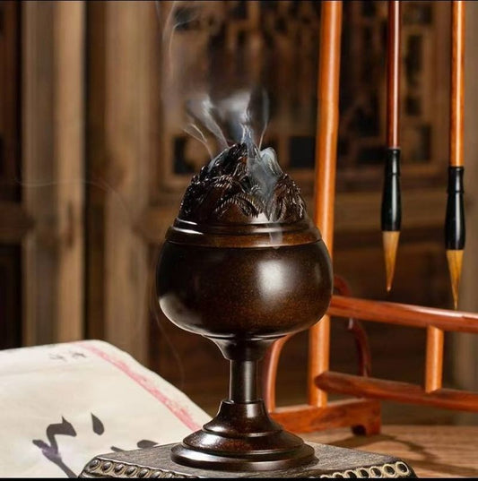 Layered peaks shrouded in clouds incense burner